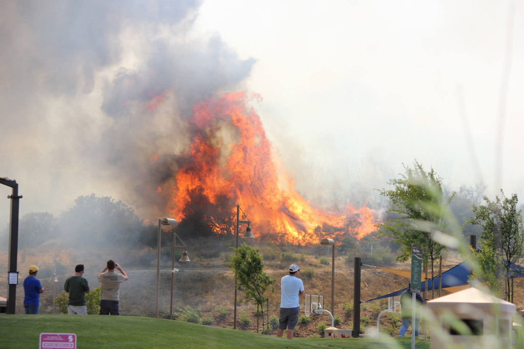 people watching a fire in california