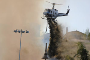 california wildfire being put out by helicopter